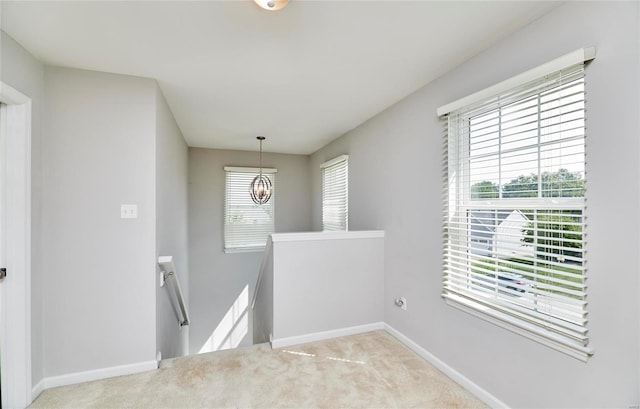 120 Kelcross, Wentzville, MO 63385 - hallway featuring an upstairs landing, baseboards, carpet floors, and a chandelier