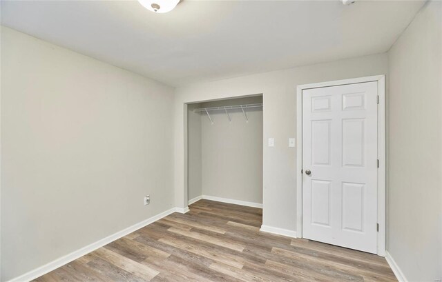 120 Kelcross, Wentzville, MO 63385 - unfurnished bedroom featuring wood finished floors, a closet, and baseboards