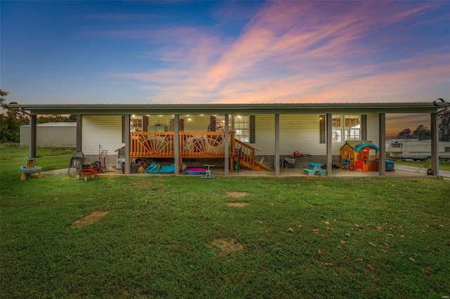 4002 County Road 20, Belleview, MO 63623 - back of house at dusk featuring a yard and a wooden deck