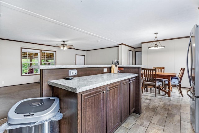 4002 County Road 20, Belleview, MO 63623 - kitchen featuring freestanding refrigerator, crown molding, dark brown cabinets, light countertops, and pendant lighting