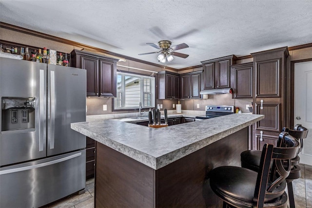 4002 County Road 20, Belleview, MO 63623 - kitchen featuring appliances with stainless steel finishes, under cabinet range hood, ceiling fan, dark brown cabinets, and a textured ceiling