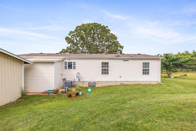 4002 County Road 20, Belleview, MO 63623 - back of property with a yard and cooling unit