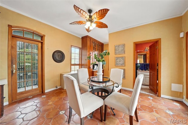 dining room with ornamental molding, ceiling fan, and baseboards