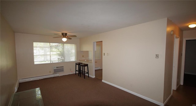 carpeted spare room featuring a baseboard radiator, a wall unit AC, a ceiling fan, and baseboards