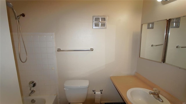 bathroom with a sink, toilet, and shower / bath combination