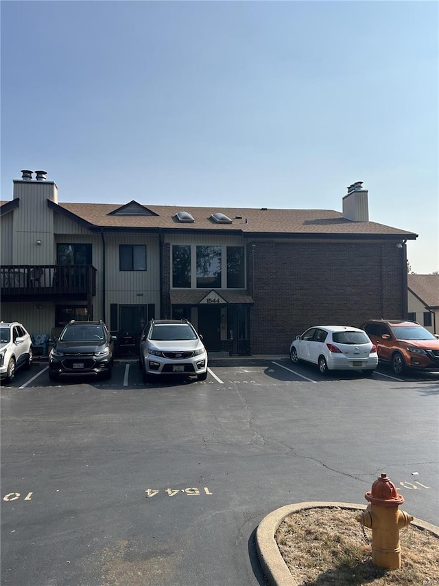 view of building exterior featuring uncovered parking
