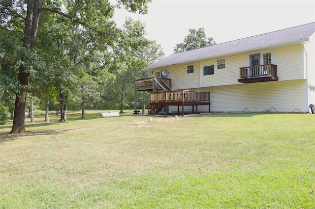 view of green lawn with a wooden deck