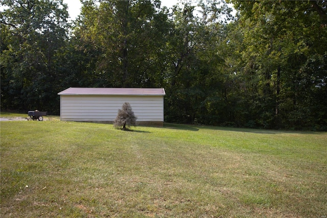 view of green lawn featuring an outbuilding and a storage unit