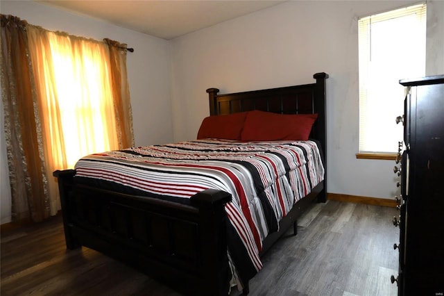 bedroom with wood finished floors and baseboards