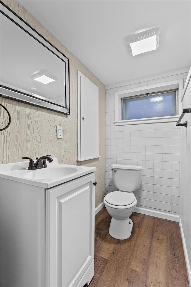 4634 Tyrolean Ave, Saint Louis, MO 63116 - half bath featuring wood finished floors, toilet, and vanity