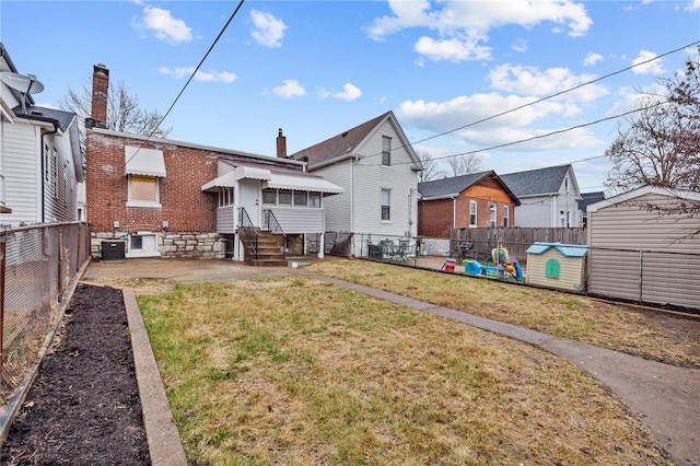 4634 Tyrolean Ave, Saint Louis, MO 63116 - rear view of house with a patio, a chimney, brick siding, cooling unit, and entry steps