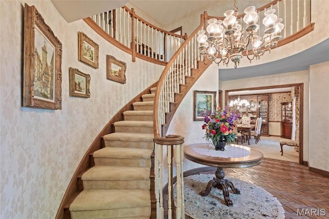 3112 Parkview Dr, Granite City, IL 62040 - stairway featuring a chandelier, wallpapered walls, and a towering ceiling