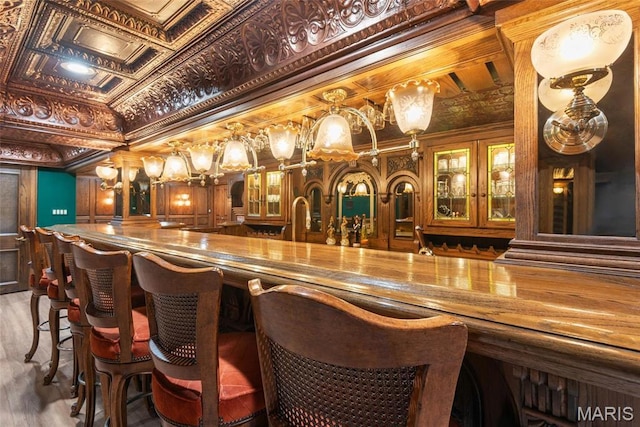 3112 Parkview Dr, Granite City, IL 62040 - indoor wet bar featuring wood finished floors, ornamental molding, and an ornate ceiling