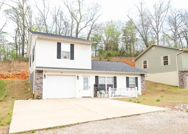 114 Mayson Ln, Poplar Bluff, MO 63901 - traditional home with driveway, an attached garage, a porch, and stone siding