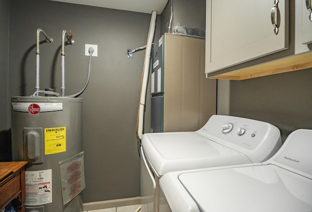 114 Mayson Ln, Poplar Bluff, MO 63901 - laundry area featuring washer and dryer, water heater, cabinet space, and baseboards