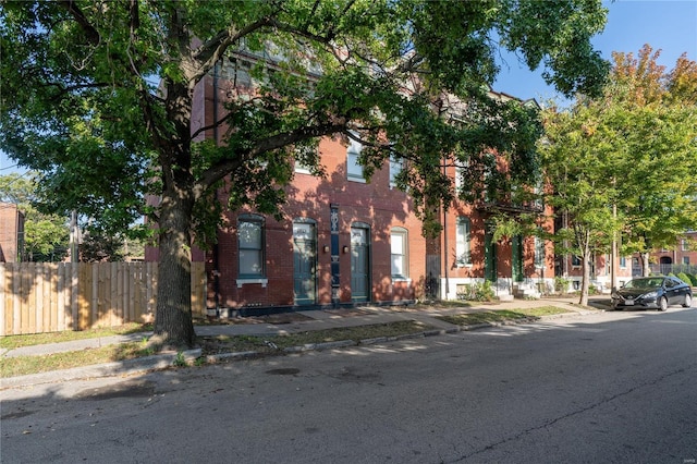2021 S 8th St, Saint Louis, MO 63104 - view of front of home featuring brick siding and fence