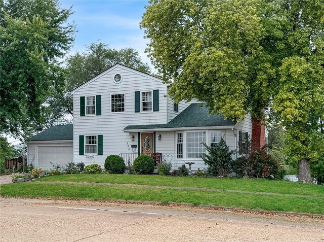 520 N Main St, Louisiana, MO 63353 - traditional-style house with a garage, a front yard, roof with shingles, and driveway