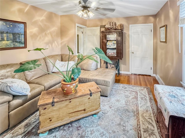 520 N Main St, Louisiana, MO 63353 - living room featuring wood finished floors, a ceiling fan, and baseboards