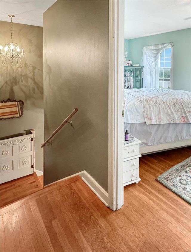 520 N Main St, Louisiana, MO 63353 - staircase featuring wood finished floors, a chandelier, and baseboards