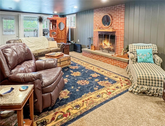 520 N Main St, Louisiana, MO 63353 - living area featuring carpet floors, a brick fireplace, and wood walls