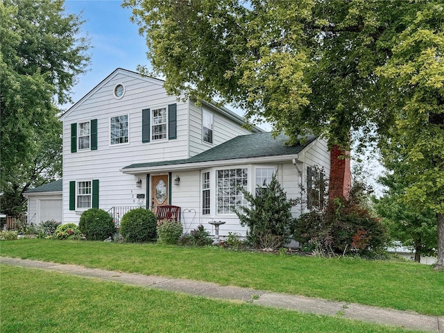 520 N Main St, Louisiana, MO 63353 - view of front of house with a front yard, a chimney, a garage, and a shingled roof