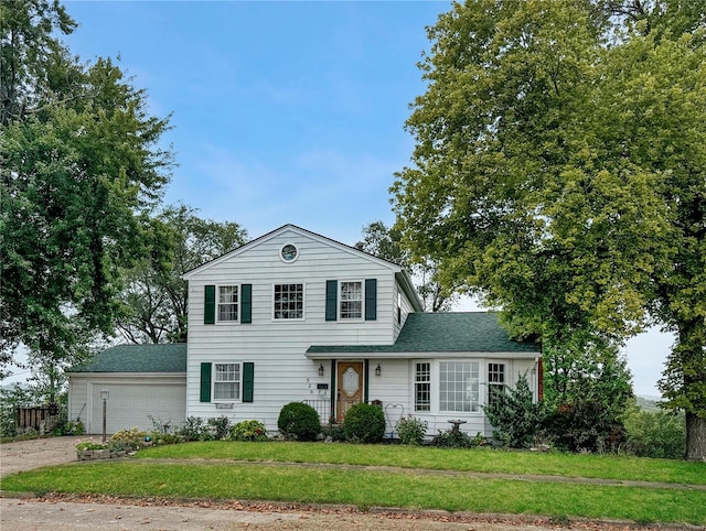 520 N Main St, Louisiana, MO 63353 - traditional home featuring concrete driveway, a front lawn, a garage, and roof with shingles