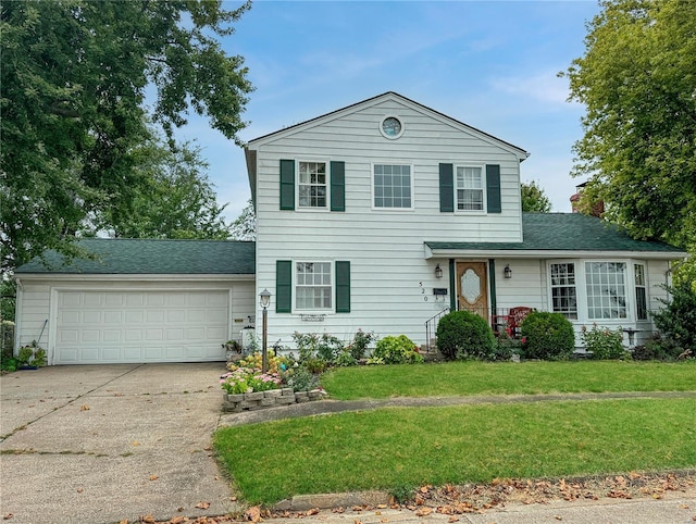 520 N Main St, Louisiana, MO 63353 - traditional home with concrete driveway, a garage, a front lawn, a chimney, and roof with shingles