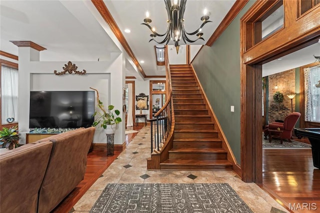 3623 Ohio Ave, Saint Louis, MO 63118 - stairs with a chandelier, ornamental molding, and wood finished floors