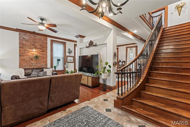 3623 Ohio Ave, Saint Louis, MO 63118 - tiled living room with stairs, crown molding, a ceiling fan, and a chandelier