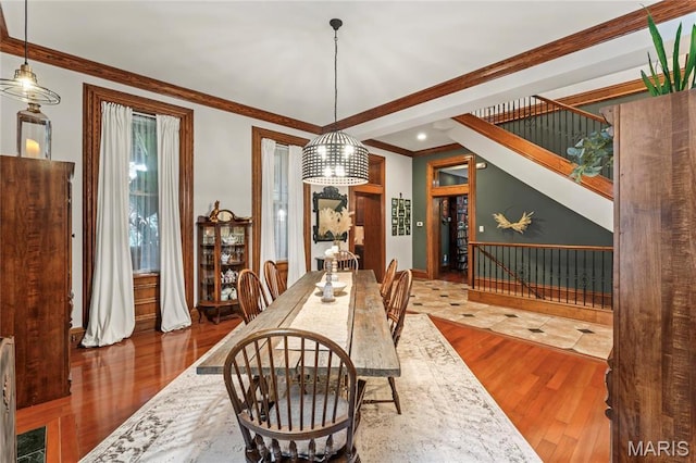 3623 Ohio Ave, Saint Louis, MO 63118 - dining space featuring wood finished floors, ornamental molding, and stairway