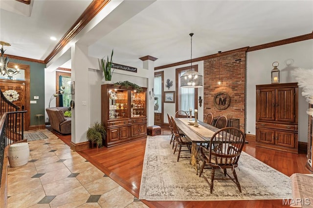 3623 Ohio Ave, Saint Louis, MO 63118 - dining area featuring a chandelier, light wood-style floors, and crown molding