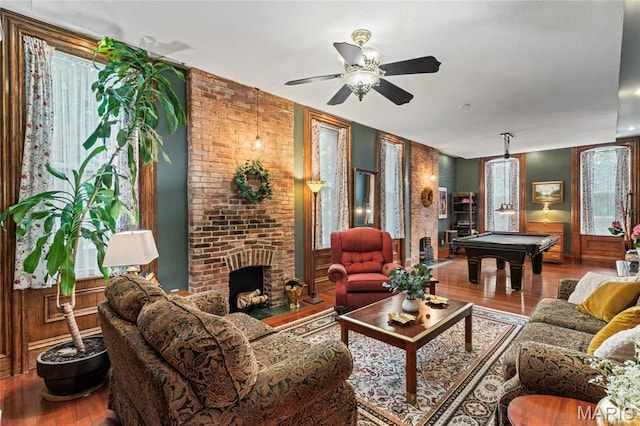 3623 Ohio Ave, Saint Louis, MO 63118 - living area featuring billiards, wood finished floors, a brick fireplace, and ceiling fan
