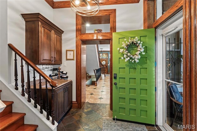 3623 Ohio Ave, Saint Louis, MO 63118 - entrance foyer featuring stairway, dark stone finish flooring, and ornamental molding