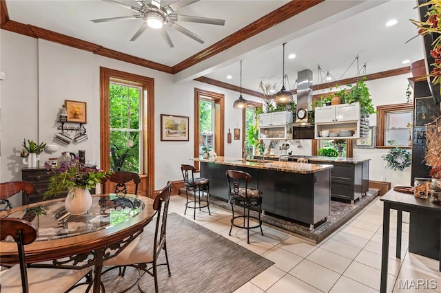 3623 Ohio Ave, Saint Louis, MO 63118 - kitchen featuring island exhaust hood, a center island with sink, ornamental molding, ceiling fan, and light tile patterned flooring