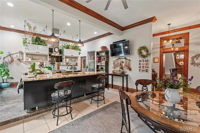 3623 Ohio Ave, Saint Louis, MO 63118 - bar area featuring ornamental molding, light tile patterned flooring, hanging light fixtures, stainless steel fridge, and recessed lighting