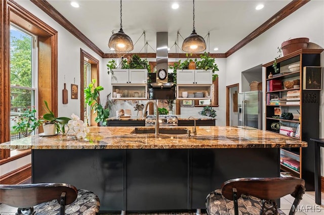3623 Ohio Ave, Saint Louis, MO 63118 - kitchen featuring stainless steel refrigerator with ice dispenser, open shelves, island exhaust hood, a kitchen bar, and recessed lighting
