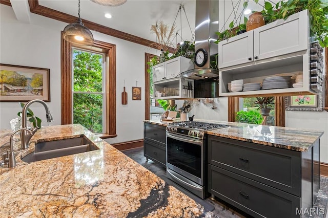 3623 Ohio Ave, Saint Louis, MO 63118 - kitchen featuring stainless steel gas range oven, exhaust hood, open shelves, light stone countertops, and pendant lighting