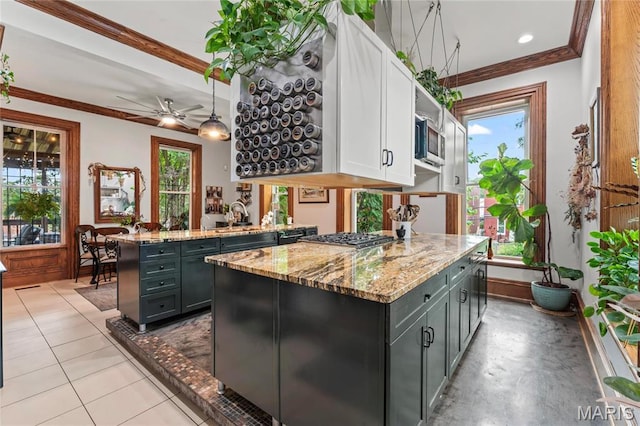 3623 Ohio Ave, Saint Louis, MO 63118 - kitchen featuring white cabinetry, appliances with stainless steel finishes, light stone countertops, a peninsula, and ornamental molding