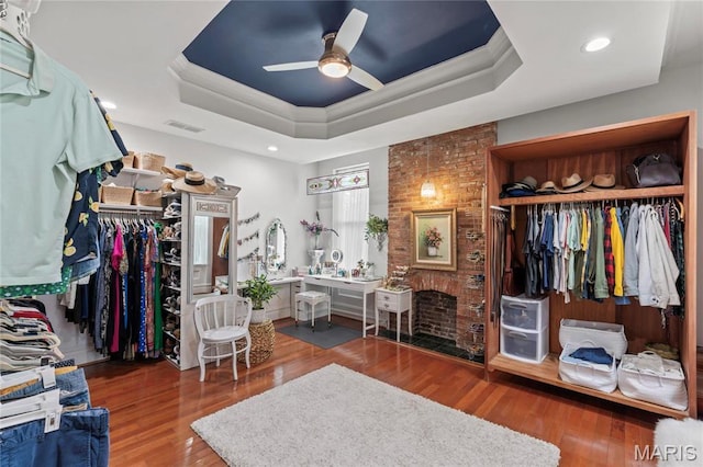 3623 Ohio Ave, Saint Louis, MO 63118 - walk in closet featuring a tray ceiling, ceiling fan, wood finished floors, and a brick fireplace
