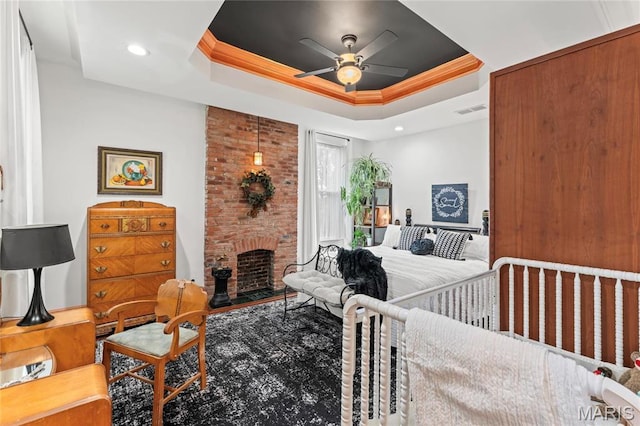 3623 Ohio Ave, Saint Louis, MO 63118 - bedroom featuring a tray ceiling, a fireplace, recessed lighting, a ceiling fan, and crown molding