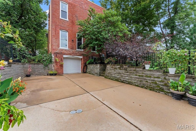 3623 Ohio Ave, Saint Louis, MO 63118 - view of front of house featuring brick siding, an attached garage, and driveway