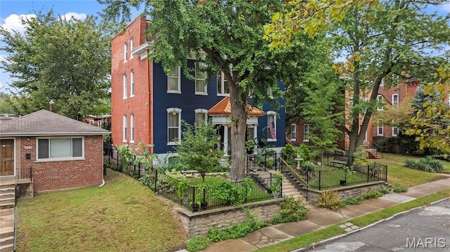 3623 Ohio Ave, Saint Louis, MO 63118 - view of front of home with brick siding and a vegetable garden