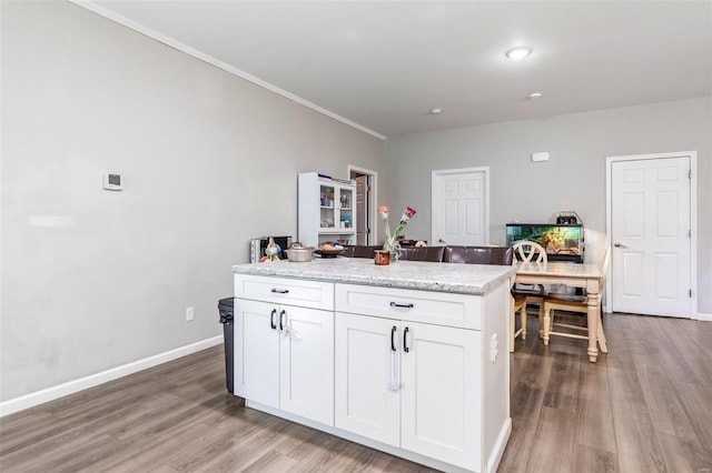 310 Crane St, Park Hills, MO 63601 - kitchen with light wood-style flooring, white cabinets, baseboards, and crown molding