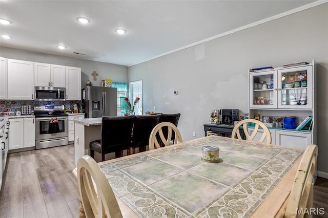 310 Crane St, Park Hills, MO 63601 - dining space featuring light wood finished floors, recessed lighting, and crown molding