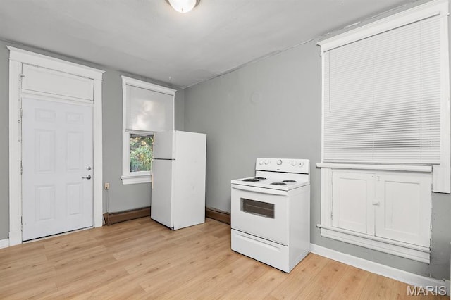 kitchen featuring white appliances, baseboard heating, light wood finished floors, and baseboards