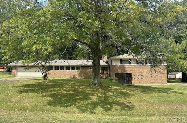 16347 Crestview Dr, Dexter, MO 63841 - split level home with brick siding, a front lawn, a garage, and a chimney