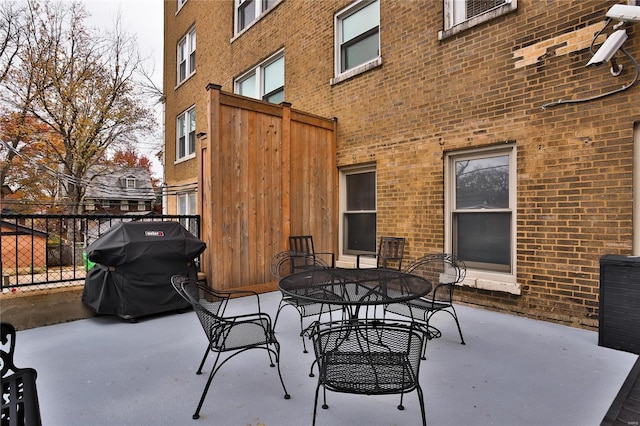 view of patio / terrace featuring grilling area, fence, and outdoor dining space