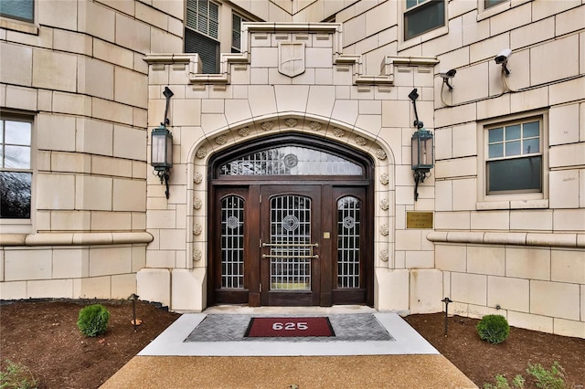 entrance to property featuring stone siding