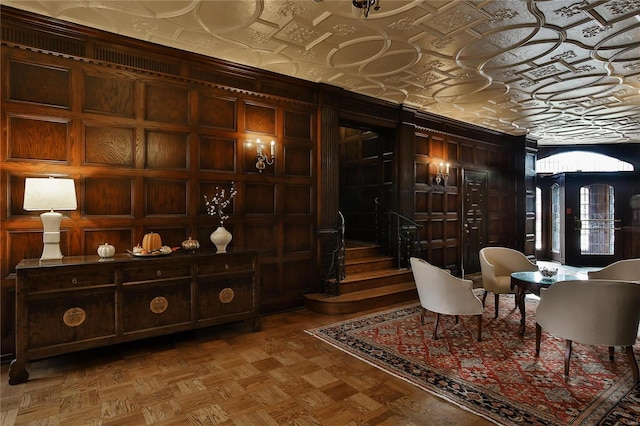 wine cellar featuring an ornate ceiling and wood walls