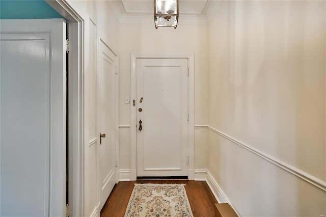 entryway with dark wood-style floors and ornamental molding
